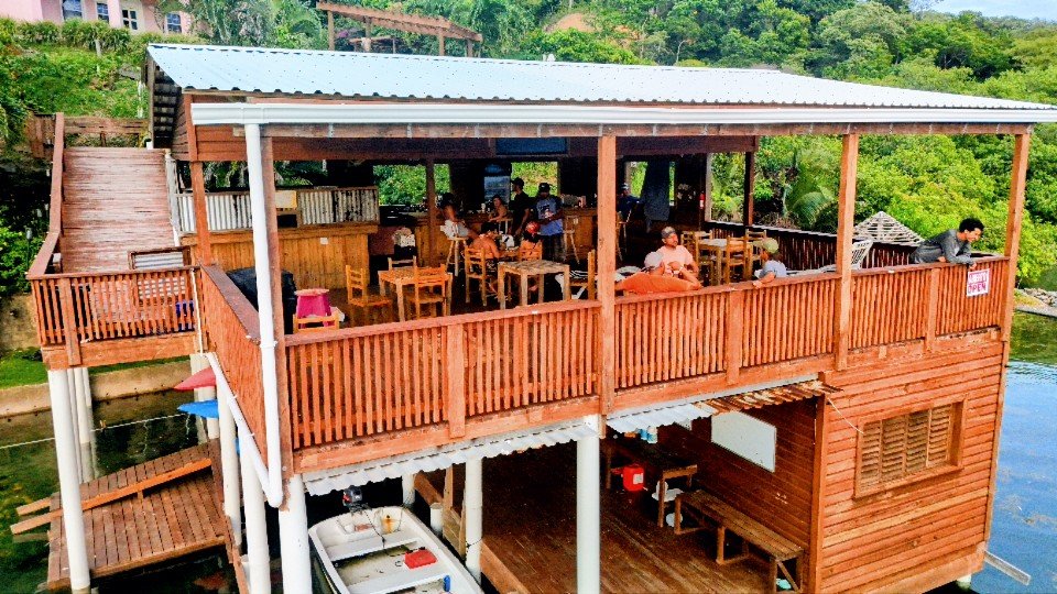 Waterfront dining area at La Rosa Tiki Bar on Carib Bight